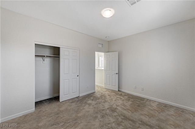 unfurnished bedroom with light carpet and a closet