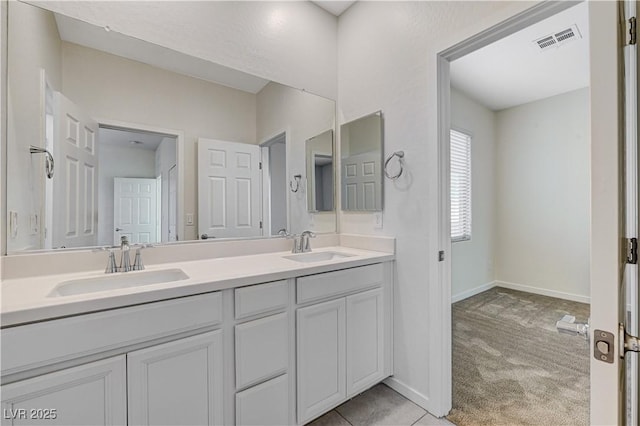 bathroom with tile patterned floors and vanity