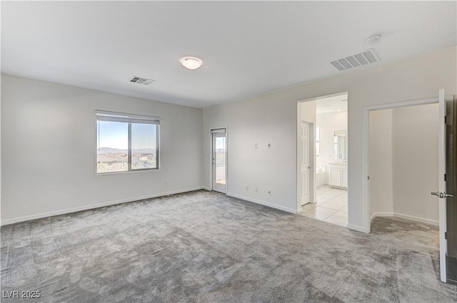 spare room with light colored carpet