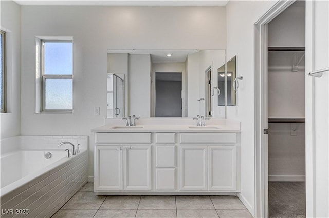 bathroom featuring vanity, tile patterned flooring, and shower with separate bathtub