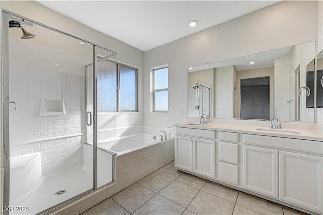 bathroom with vanity, tile patterned flooring, and shower with separate bathtub