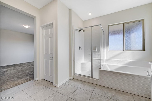 bathroom with shower with separate bathtub and tile patterned floors