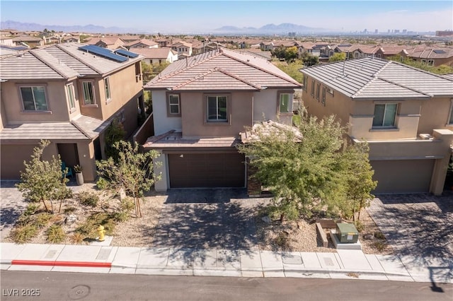 view of front of property with a garage and a mountain view