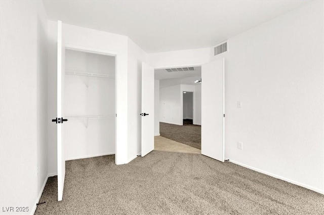 unfurnished bedroom featuring carpet floors and a closet