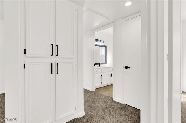 hallway with light colored carpet