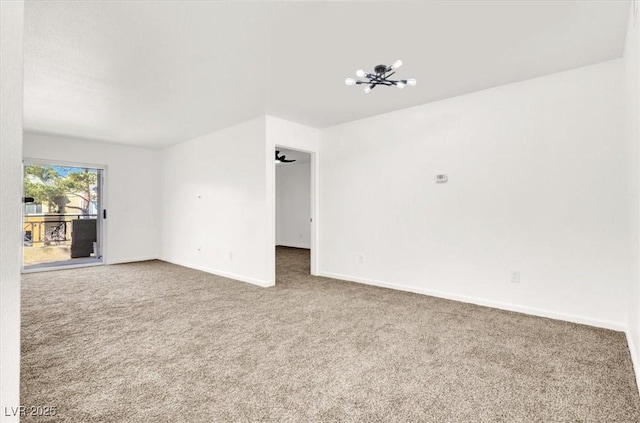 unfurnished living room with an inviting chandelier and carpet flooring