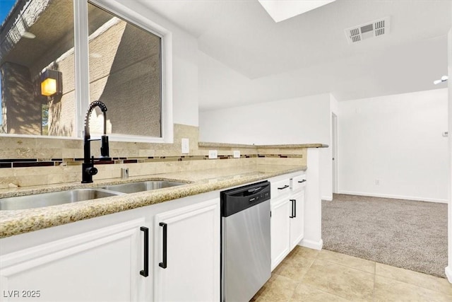 kitchen with light carpet, white cabinetry, dishwasher, light stone counters, and sink