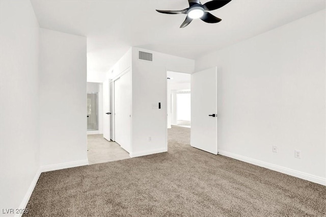 carpeted empty room with ceiling fan