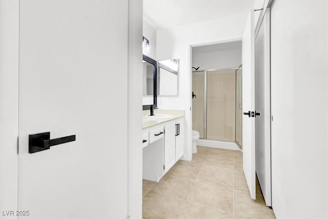 bathroom with an enclosed shower, vanity, and toilet