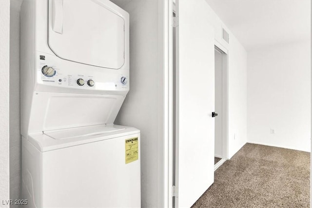 laundry area featuring dark carpet and stacked washer and clothes dryer