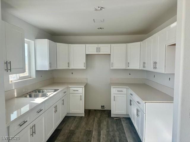 kitchen featuring white cabinets, dark hardwood / wood-style floors, and sink