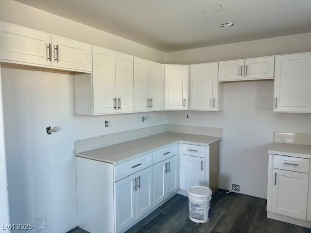 kitchen featuring dark hardwood / wood-style flooring and white cabinetry