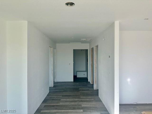 hallway with dark hardwood / wood-style flooring