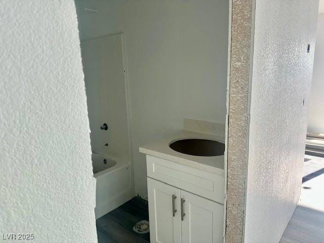 bathroom featuring shower / bath combination, wood-type flooring, and vanity