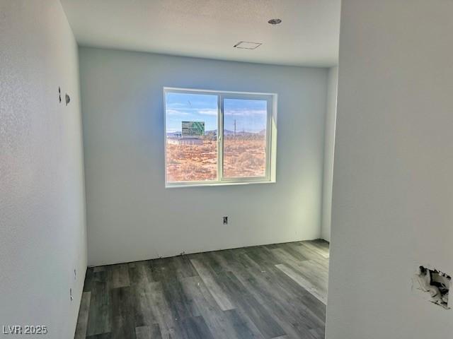 empty room with hardwood / wood-style floors