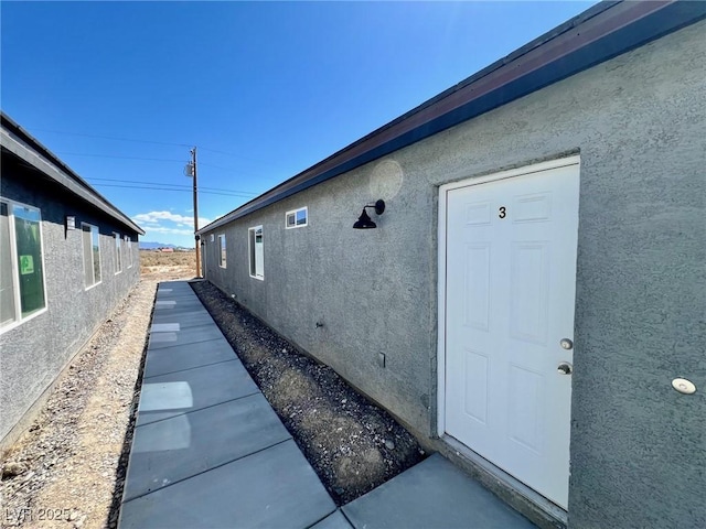 view of side of property with stucco siding