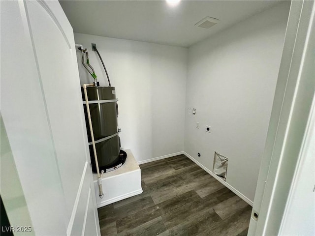 washroom with laundry area, wood finished floors, baseboards, electric dryer hookup, and strapped water heater
