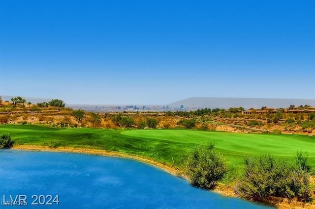 surrounding community featuring a water view and a lawn