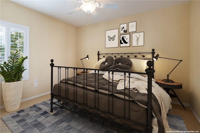 bedroom featuring ceiling fan and carpet