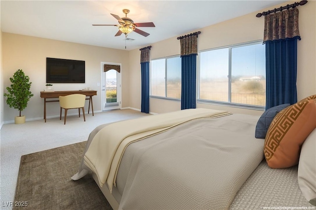 carpeted bedroom with ceiling fan and multiple windows