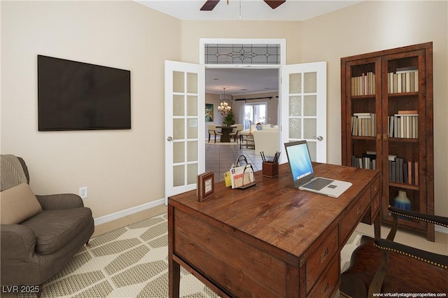 home office with carpet flooring and ceiling fan with notable chandelier