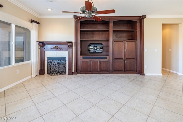 unfurnished living room featuring ceiling fan, a wealth of natural light, a tiled fireplace, light tile patterned flooring, and ornamental molding