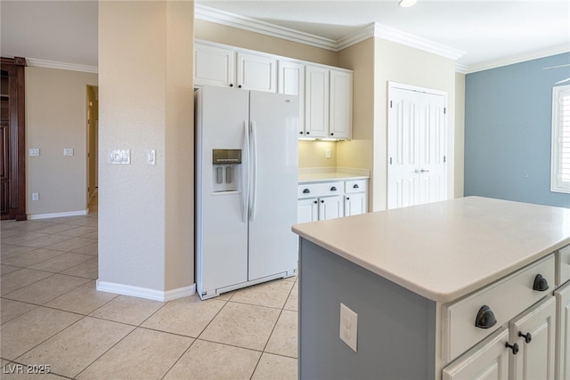 kitchen with light tile patterned floors, white cabinetry, white fridge with ice dispenser, a kitchen island, and crown molding