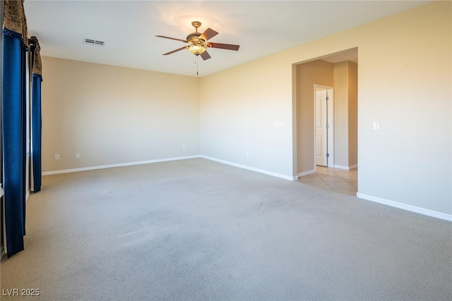 spare room featuring ceiling fan and light carpet