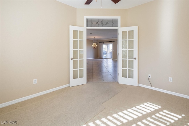 unfurnished room featuring carpet, ceiling fan with notable chandelier, and french doors