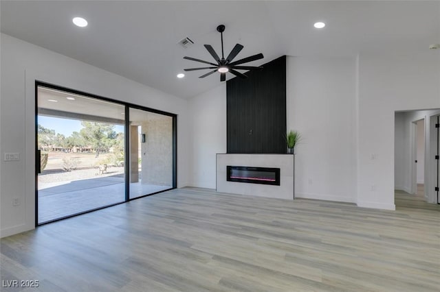 unfurnished living room featuring ceiling fan and light hardwood / wood-style flooring