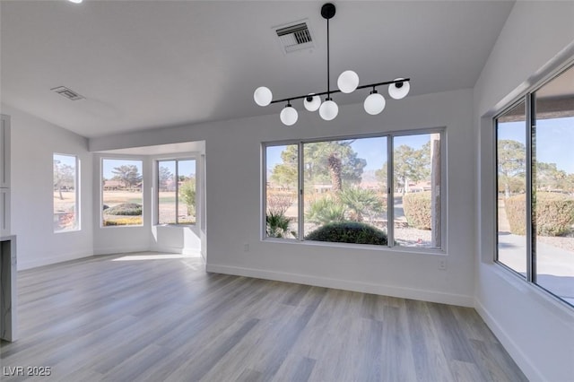 unfurnished dining area featuring a wealth of natural light and light hardwood / wood-style floors