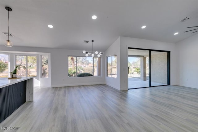 unfurnished living room featuring ceiling fan, light wood-type flooring, and vaulted ceiling