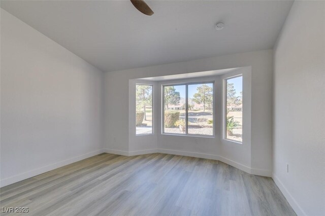 empty room featuring ceiling fan and light hardwood / wood-style floors