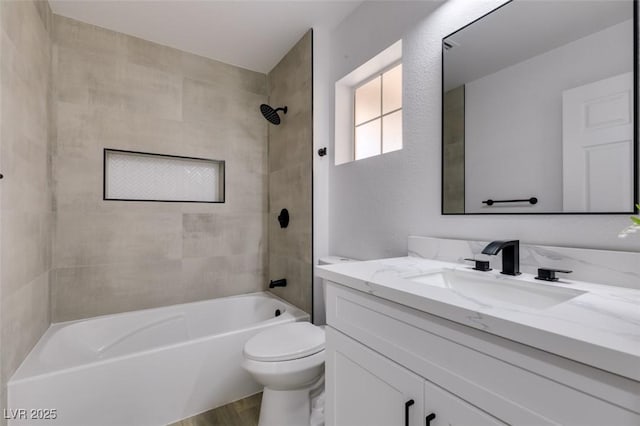 full bathroom with hardwood / wood-style floors, toilet, vanity, and tiled shower / bath