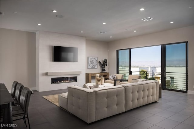 tiled living room featuring a tiled fireplace