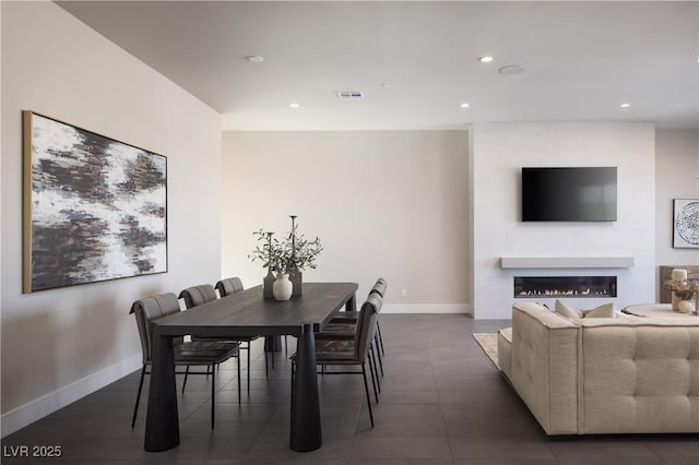 dining area with a large fireplace