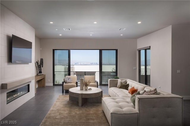 living room with a tiled fireplace