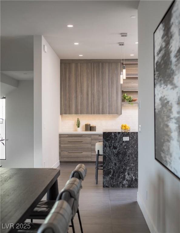 interior space with decorative light fixtures and decorative backsplash