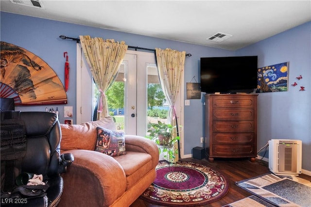 living room featuring dark wood-type flooring and french doors