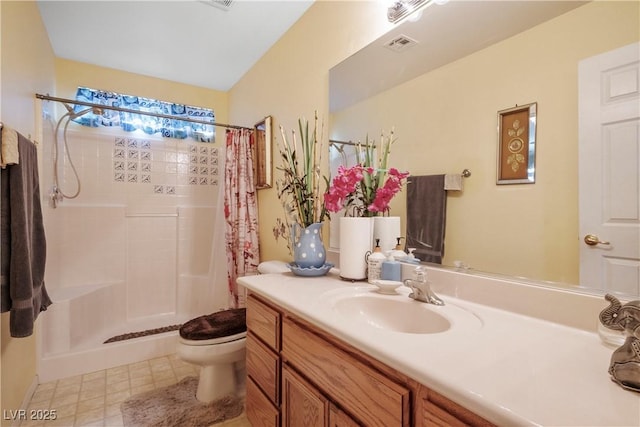 bathroom featuring toilet, vanity, and a shower with curtain