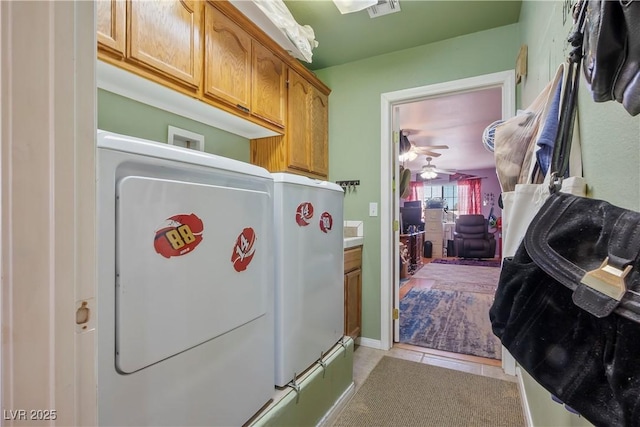 washroom featuring ceiling fan, cabinets, and light tile patterned floors