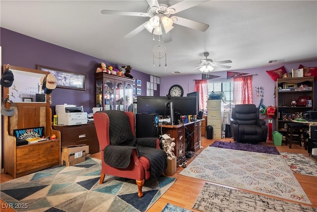 office space featuring ceiling fan and light hardwood / wood-style floors