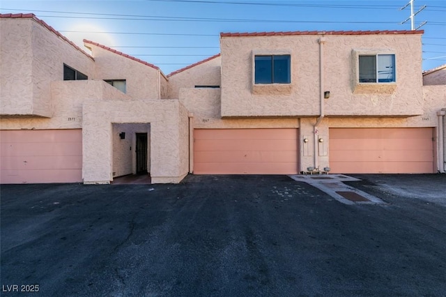 townhome / multi-family property featuring a garage