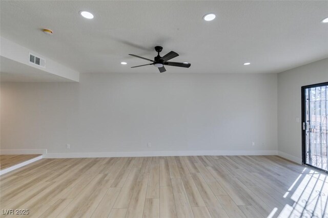 spare room with ceiling fan and light hardwood / wood-style flooring