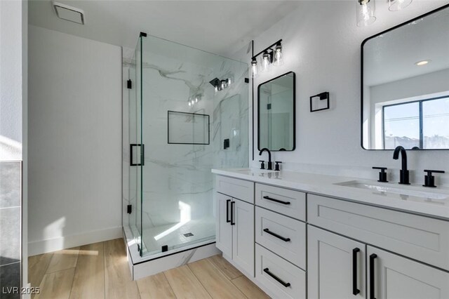 bathroom with an enclosed shower and vanity