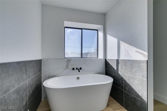 bathroom featuring a bathing tub and tile walls