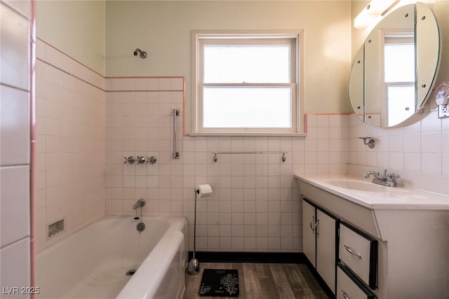 bathroom with tile walls, hardwood / wood-style flooring, and vanity