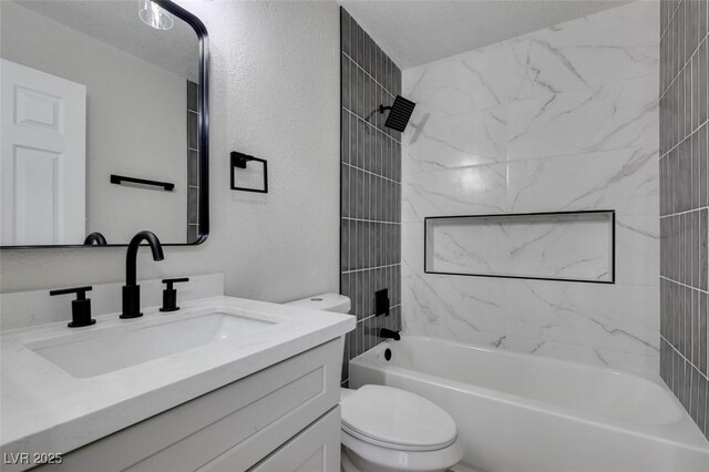 full bathroom featuring toilet, vanity, and tiled shower / bath combo