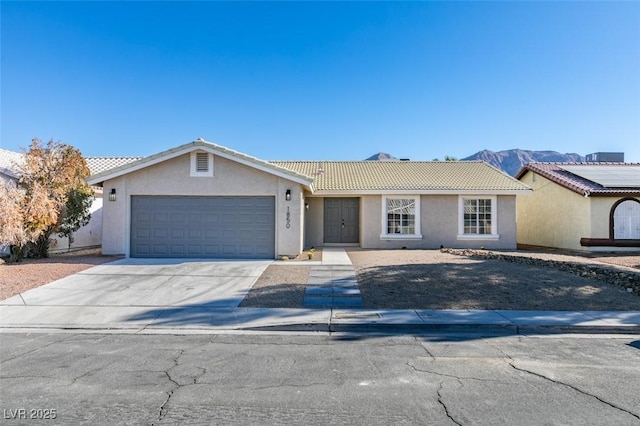 ranch-style house with a mountain view and a garage