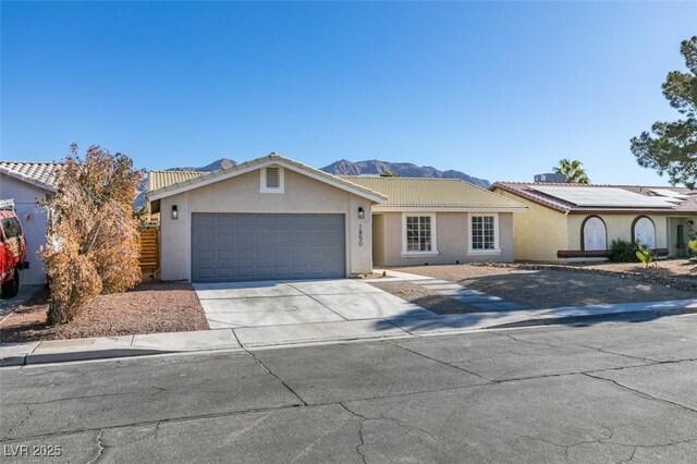 view of front facade with a garage and a mountain view